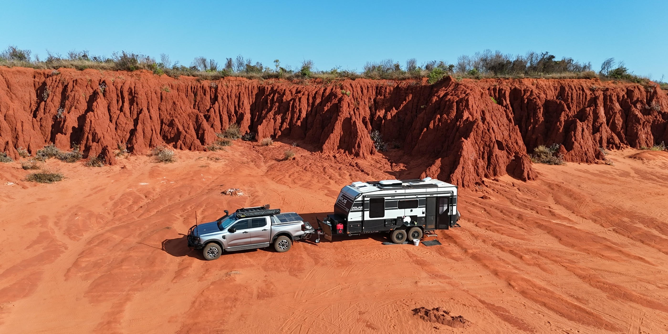 Tim and Lauren’s Ranger Sport and Atlas RVS 196 below red cliffs